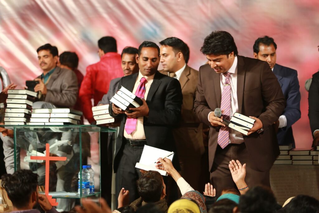 Distributing Free Urdu Bibles in Pakistan during revival crusade in Lahore Pakistan.